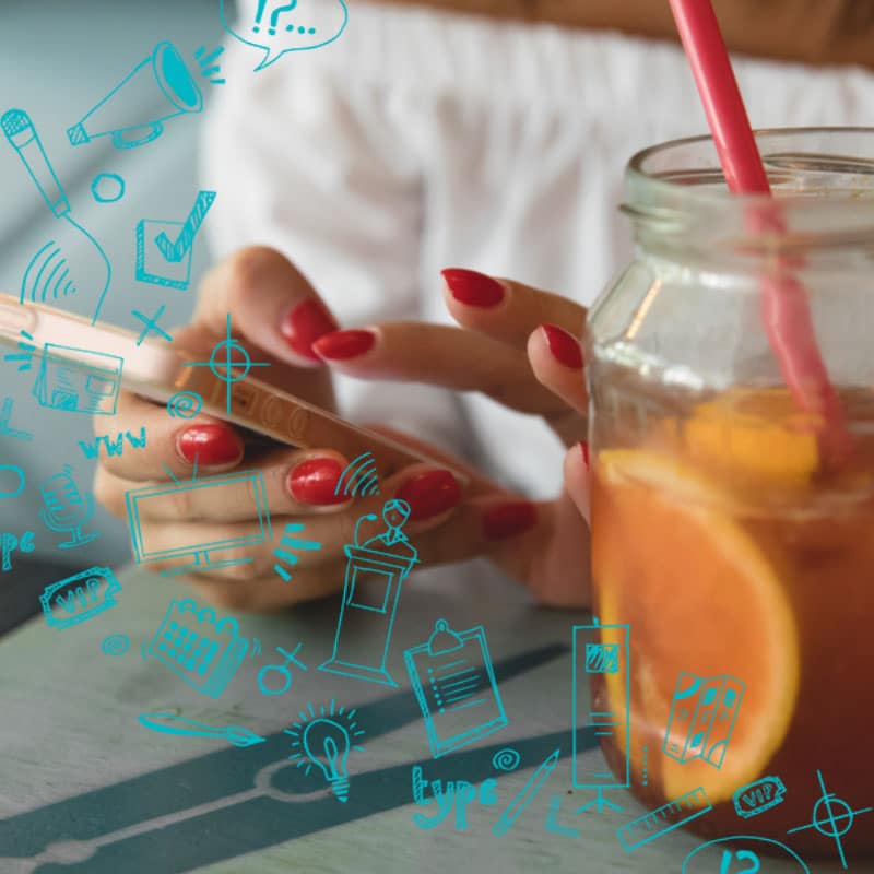 Successful social media user: Woman with red nails using smartphone, drinking orange beverage in jar, with blue doodle icons overlay.