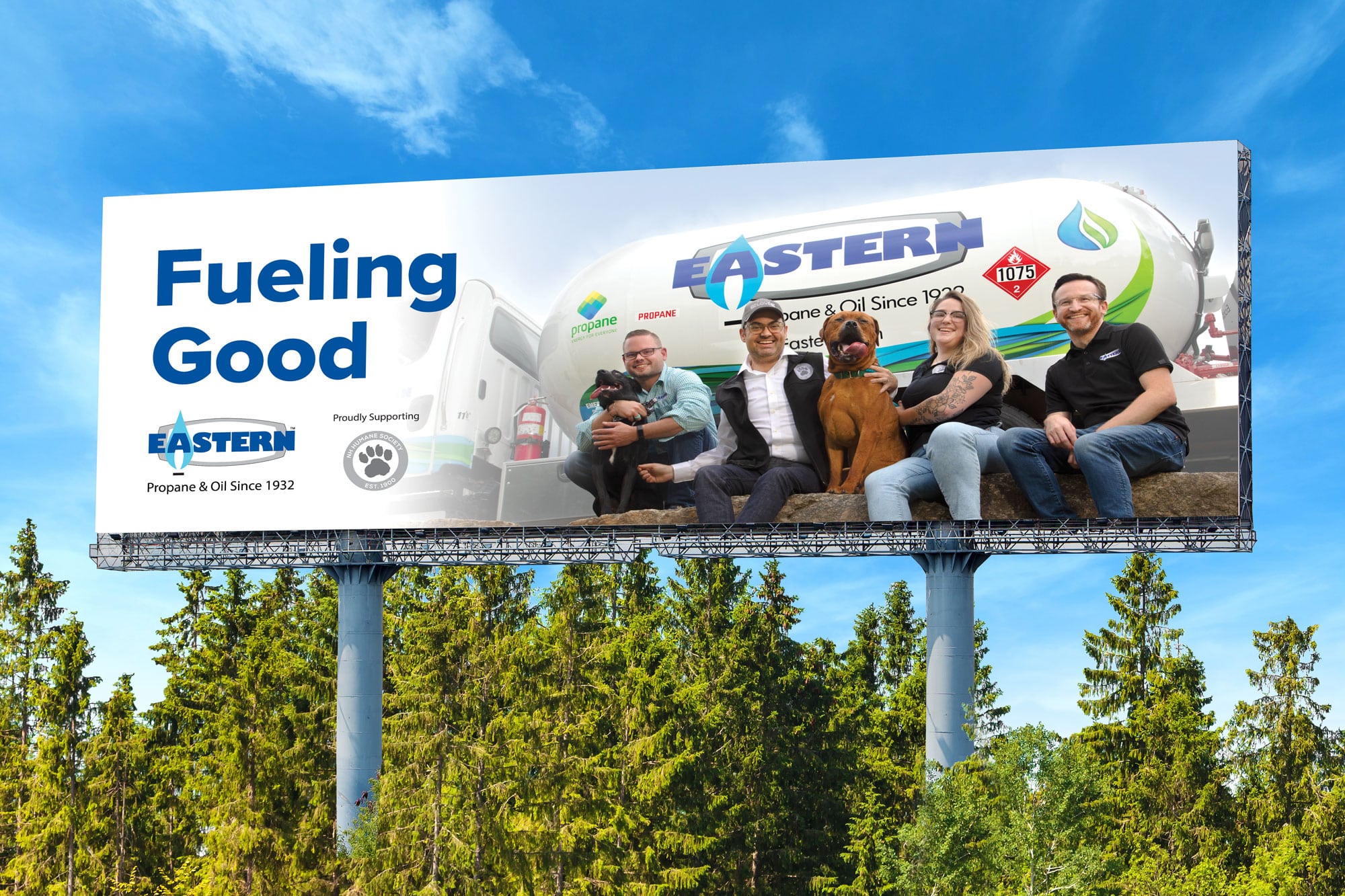A billboard reads Fueling Good with five people and two dogs sitting in front of an Eastern propane truck.