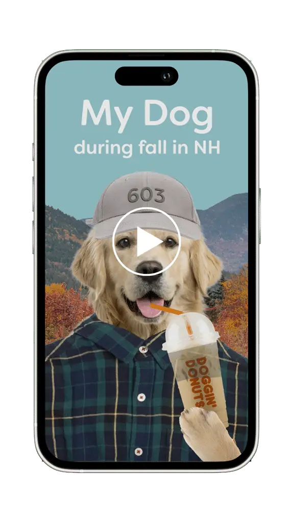 A dog in a hat and flannel holds a Doggin Donuts drink on a phone screen, perfect for sharing on social media with cozy fall scenery in the background.