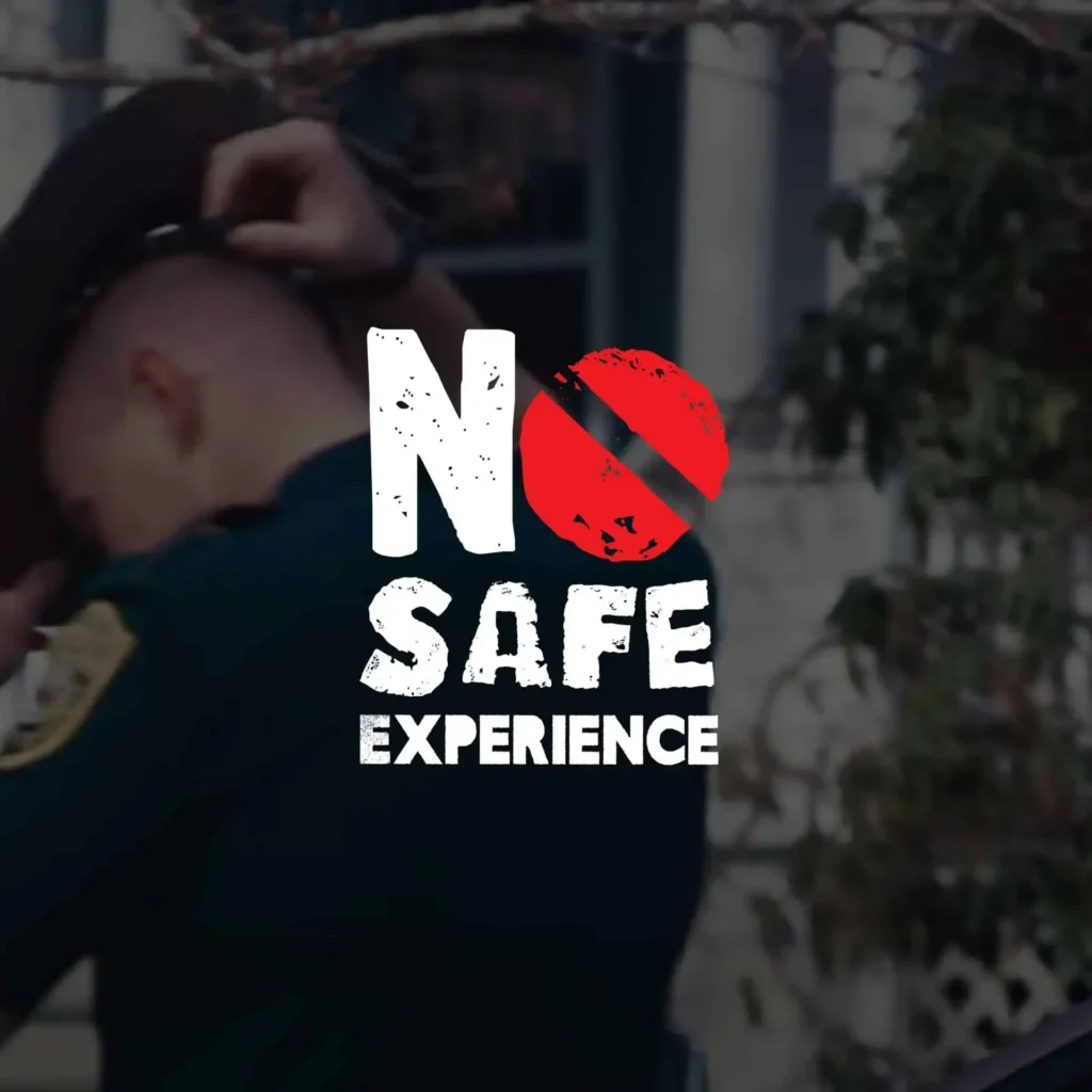 A police officer adjusts his hat; overlaid text reads No Safe Experience with a red crossed-out circle, creating a strong public awareness message.