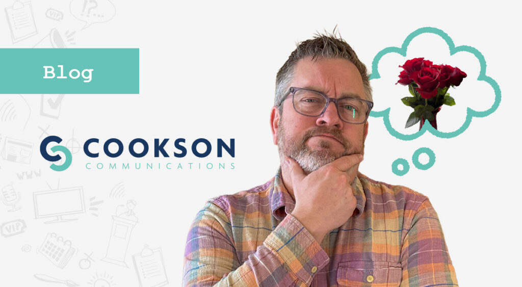 Man in glasses and plaid shirt thinking, with a thought bubble of roses above, illustrating omnichannel ideas next to Cookson Communications.