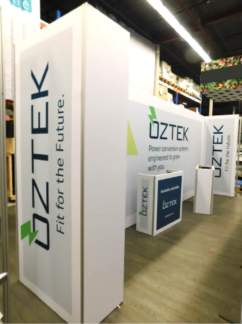 Exhibition booth with OZTEK Fit for the Future and Power conversion systems engineered to grow with you on panels.