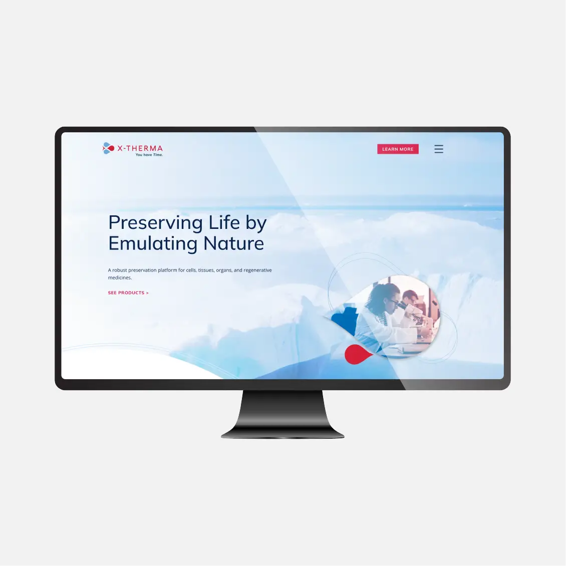 A computer monitor displays the X-Therma website homepage with the text “Preserving Life by Emulating Nature.”.